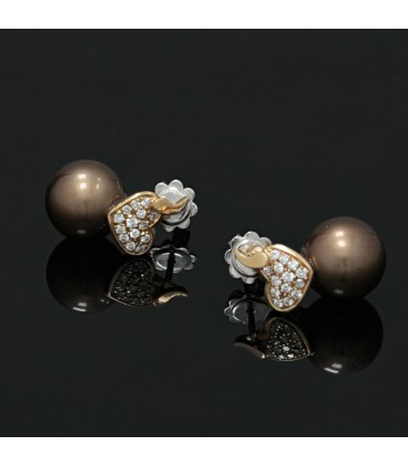 Cultured pearls, diamonds and gold earrings.